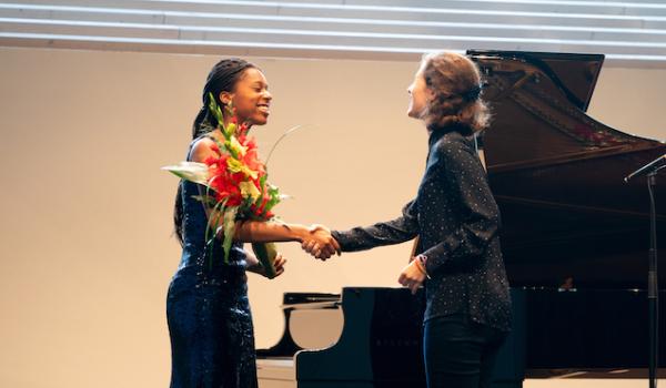 Jeneba Kanneh-Mason receives flowers after her performance.